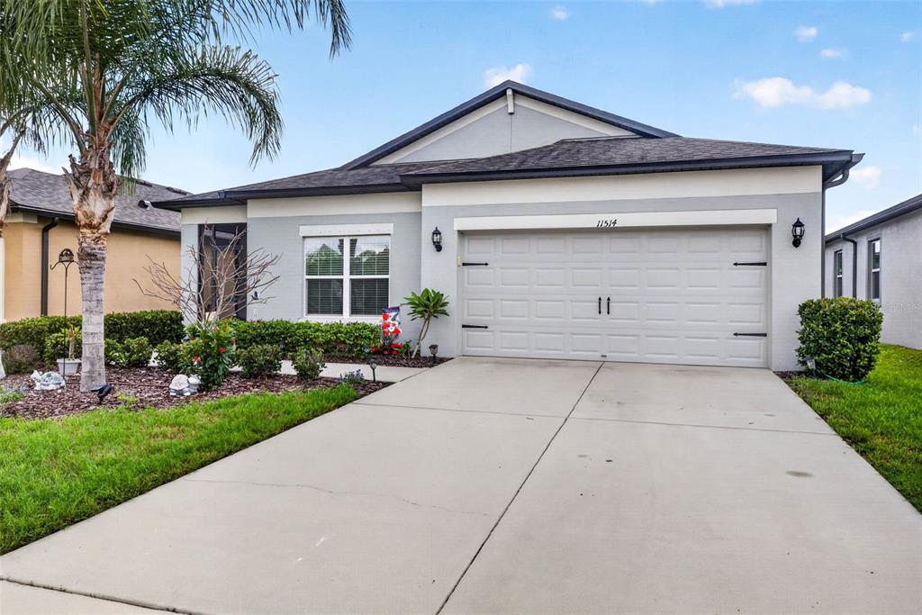 A single-story house with a gray exterior, a two-car garage, and a palm tree — 11514 LELAND GROVES DRIVE, RIVERVIEW, FL
