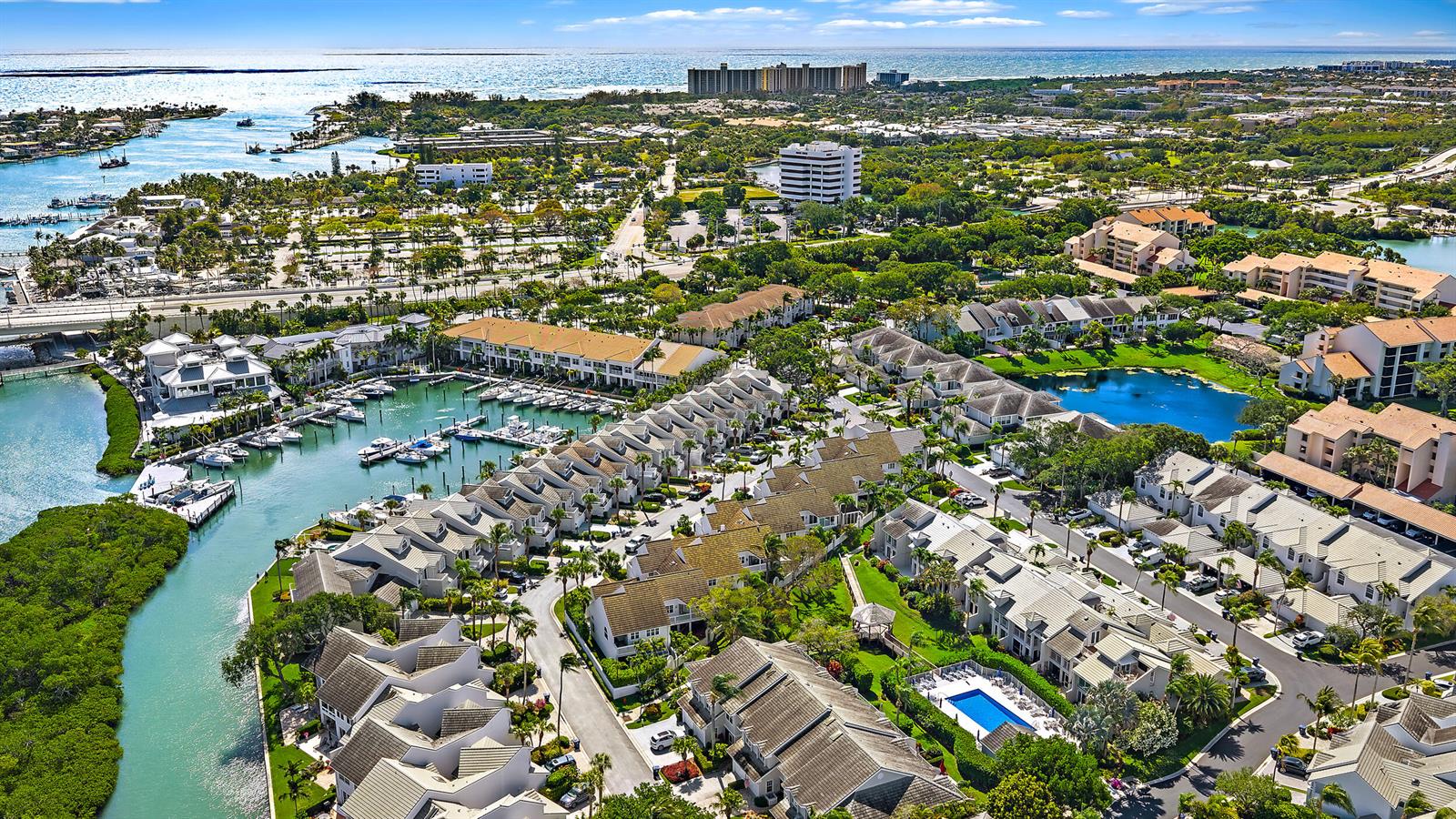 Aerial view of a coastal residential community with a marina, swimming pool, and lush landscaping — 1000 N Us Highway 1 Highway N, Jupiter FL 33477, JUPITER, FL