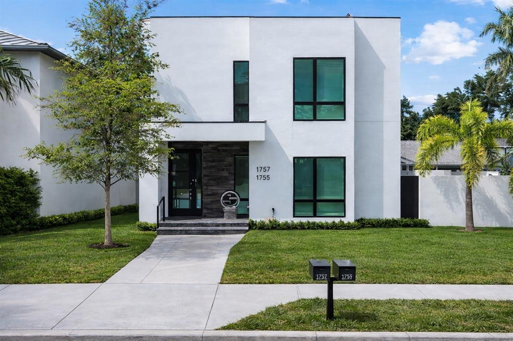 A modern two-story white house with black window frames and a stone-accented entryway — 1755 7TH STREET, SARASOTA, FL