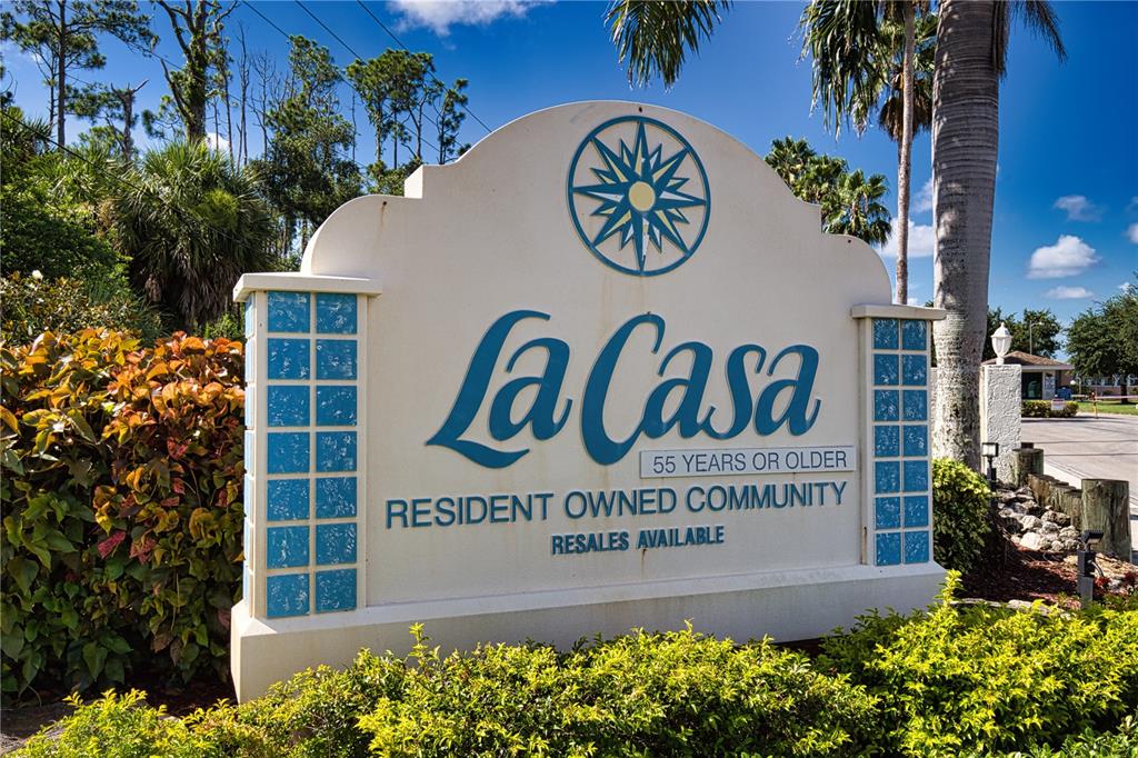 A sign for the La Casa 55+ resident-owned community stands outdoors among landscaping — 418 VIVAR, NORTH PORT, FL