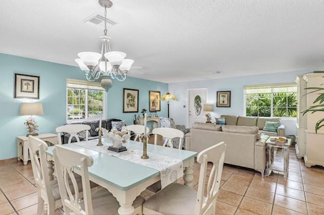 A dining area with a light blue wall and chandelier opens into a living room — 309 W Calzada De Bougainvillea, Marathon FL 33050, MARATHON, FL