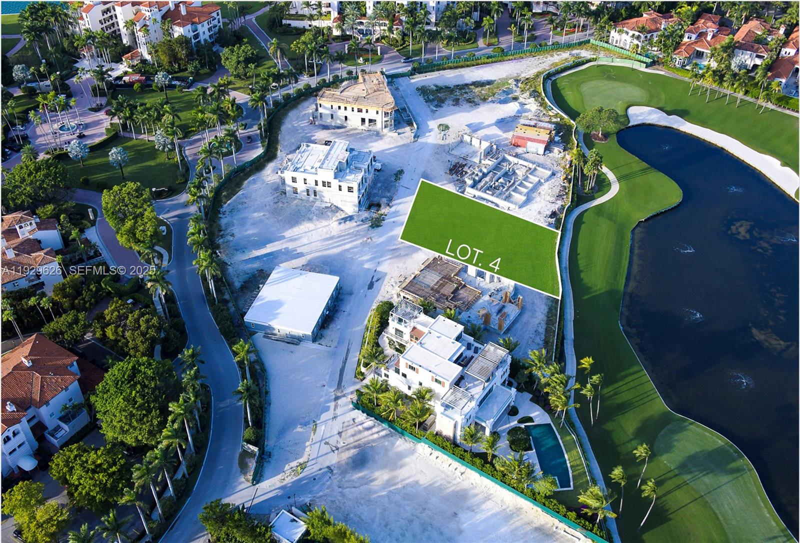 An aerial view shows a vacant lot highlighted in green situated next to a golf course — 1004 Fisher Island Drive, Miami Beach FL 33109, MIAMI BEACH, FL