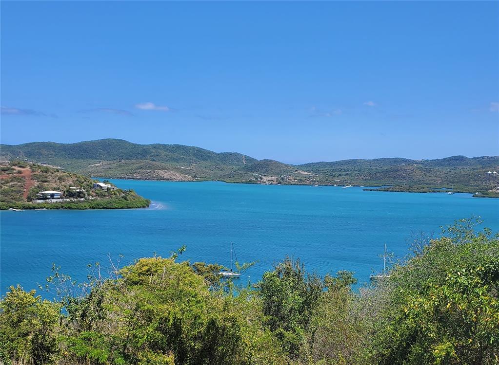 A view of a blue bay with sailboats and surrounding green hills under a clear sky — D201 BAHIA MARINA RESORT CONDOMINIUM UNIT D201, CULEBRA, PR