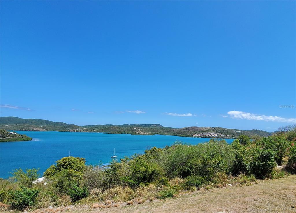 A view of a blue bay surrounded by green hills under a clear sky — D201 BAHIA MARINA RESORT CONDOMINIUM UNIT D201, CULEBRA, PR