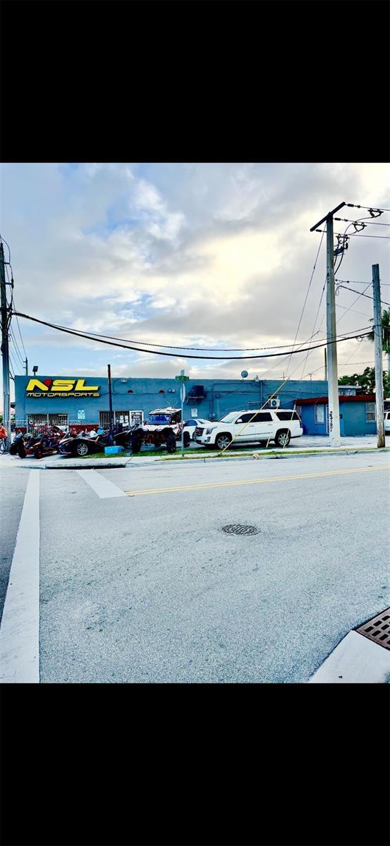 An exterior view of a blue commercial building labeled NSL Motorsports with parked vehicles — 210 SW 22nd Ave, Miami FL 33135, MIAMI, FL