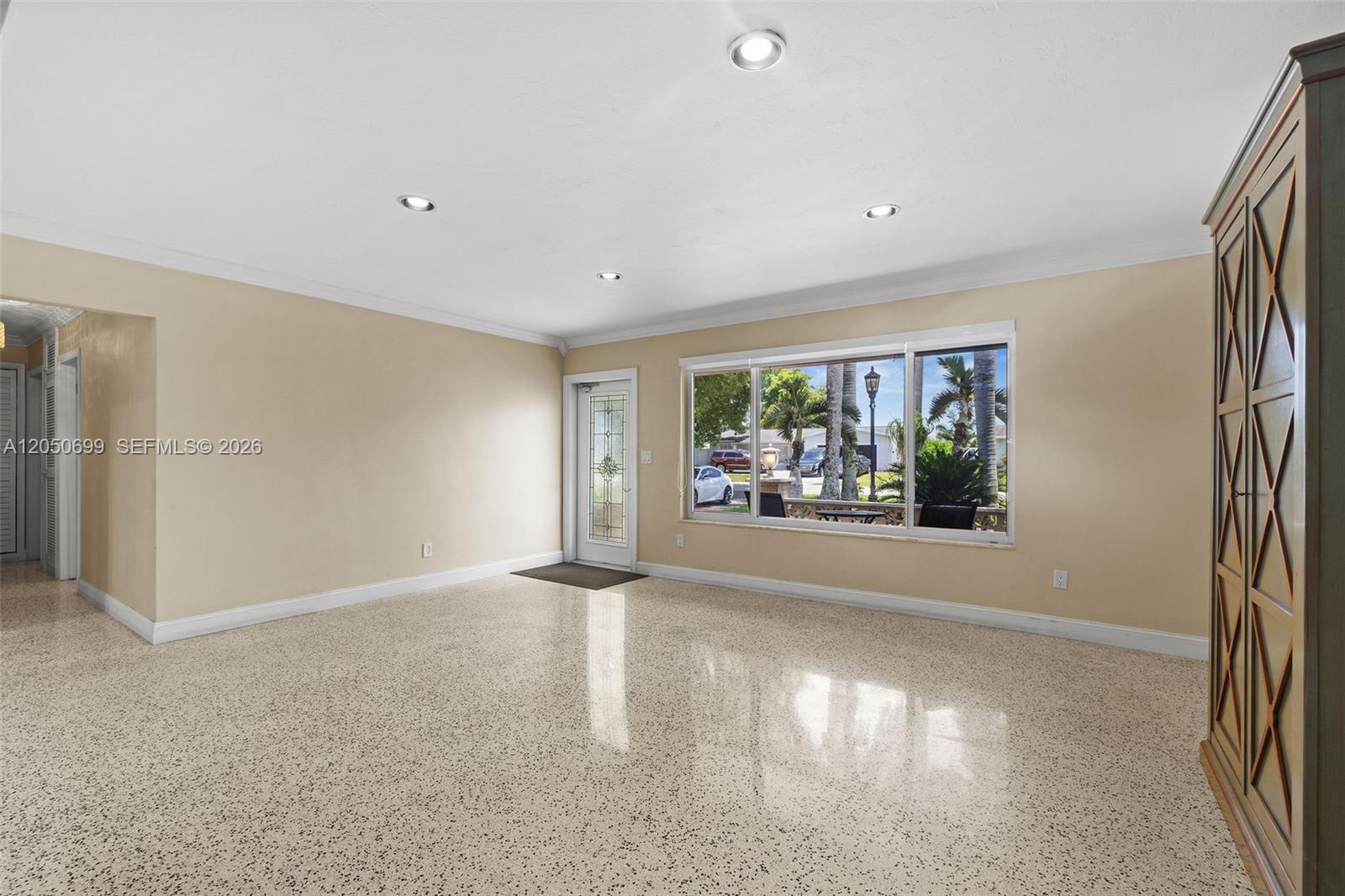 An empty room features light-colored walls, recessed lighting, and a speckled terrazzo floor — 8431 Pasadena Blvd, Pembroke Pines FL 33024, PEMBROKE PINES, FL