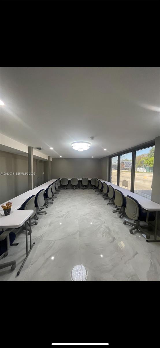 A conference room features a U-shaped table arrangement, gray rolling chairs, and white marble flooring — 5851 NW 17th Ave, Miami FL 33142, MIAMI, FL
