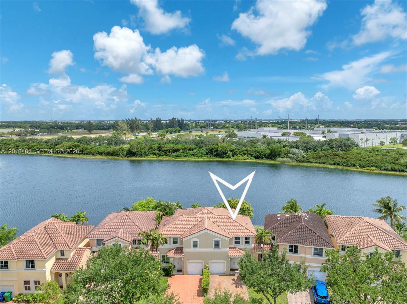 An aerial view shows a two-story townhouse with a tiled roof overlooking a lake — 16910 SW 39th Ct, Miramar FL 33027, MIRAMAR, FL