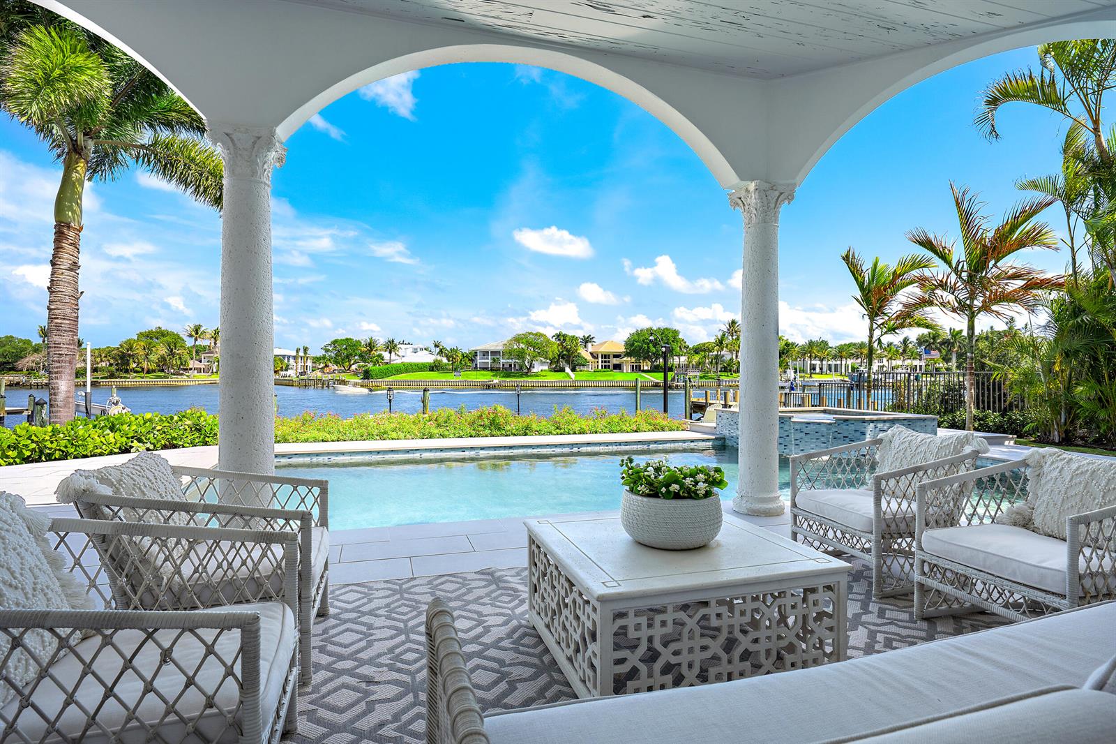 An aerial view shows a waterfront house with a boat dock on a canal — 12864 S Shore Drive, Palm Beach Gardens FL 33410, PALM BEACH GARDENS, FL
