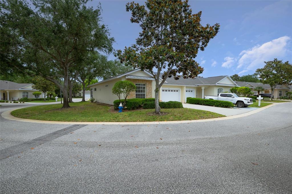 A single-story duplex with a two-car garage and a white pickup truck parked outside — 21 SUMMERWIND CIRCLE UNIT 107, PALM COAST, FL