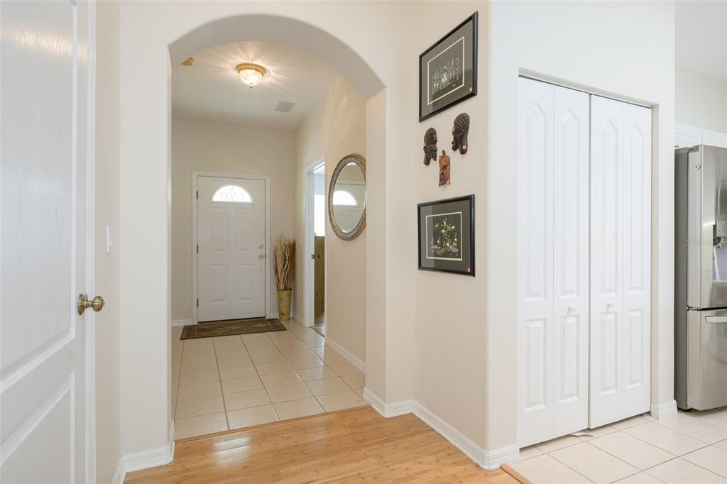 An interior view of a home entryway with tiled floors, an arched doorway, and wall decor — 21 SUMMERWIND CIRCLE UNIT 107, PALM COAST, FL