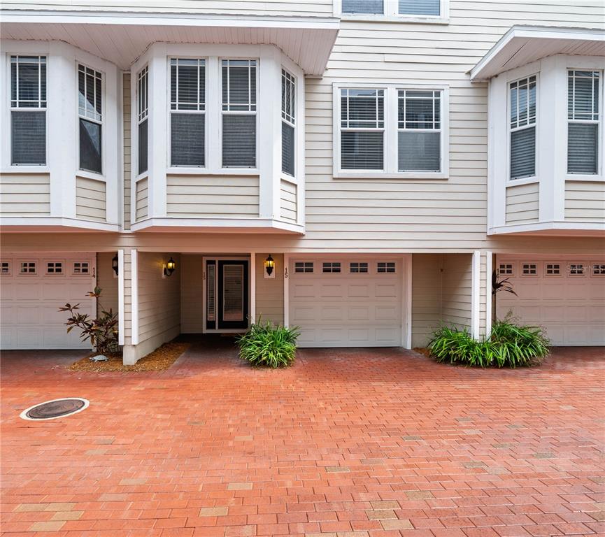 An interior view shows a wooden staircase, two white doors, and hardwood flooring — 3315 W DE LEON STREET UNIT 15, TAMPA, FL