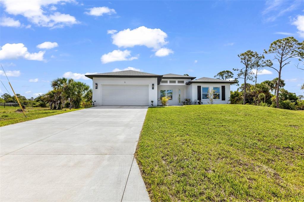 A white single-story house with a two-car garage and a concrete driveway — 5 MATE DRIVE, PLACIDA, FL