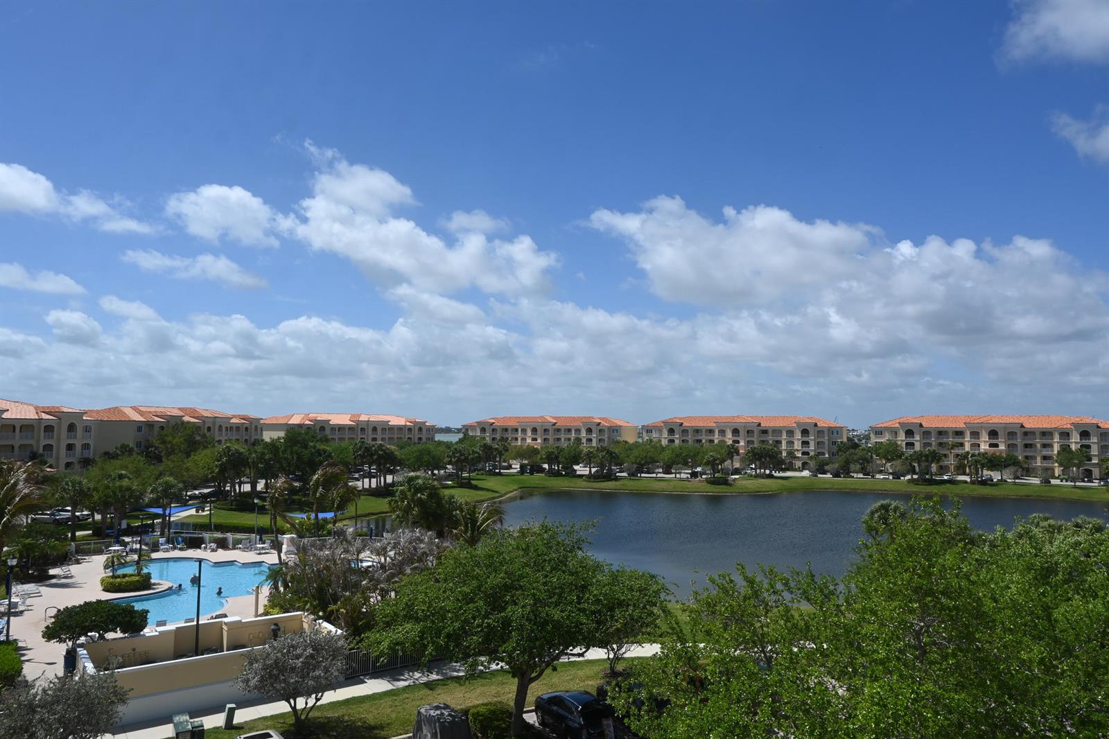 An elevated view of a resort complex with a swimming pool and a central lake — 14 Harbour Isle Drive W, Fort Pierce FL 34949, FORT PIERCE, FL