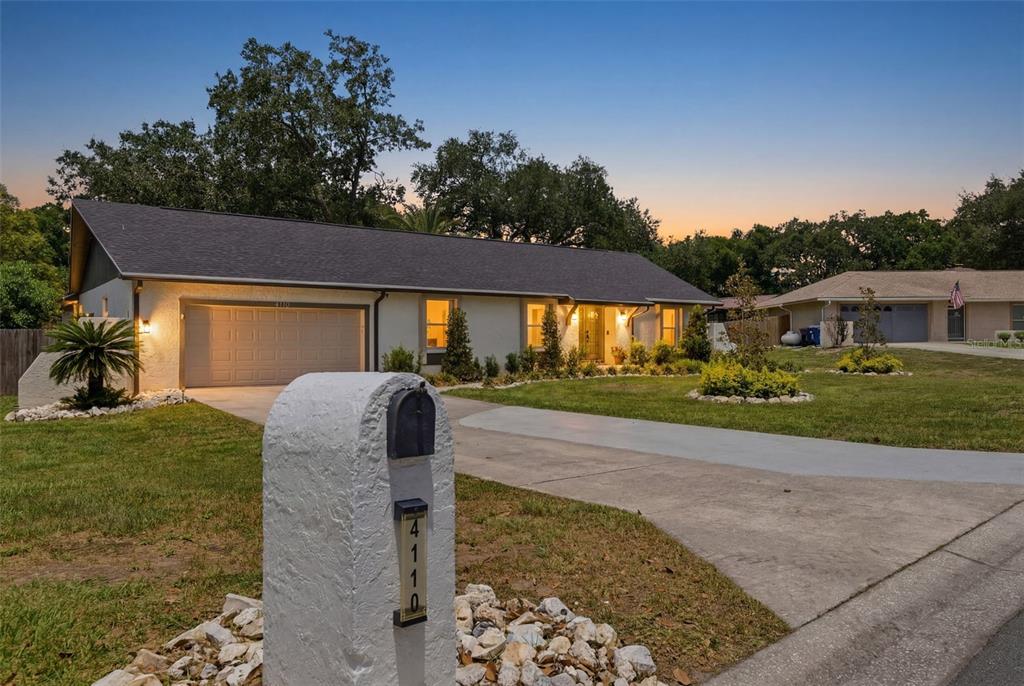 A single-story house with a garage and a white stucco mailbox at the street — 4110 HELENE PLACE, VALRICO, FL