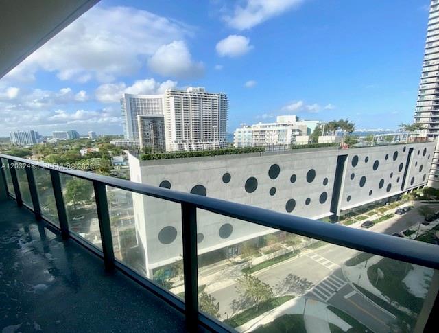 A view from a balcony overlooking a parking garage and surrounding city buildings — 501 NE 31st St # 802, Miami FL 33137, MIAMI, FL