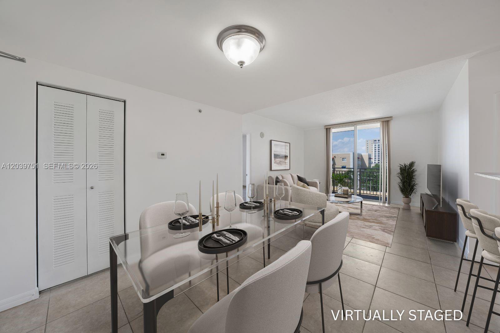 A dining area with a glass table and chairs opens into a living room — 215 SW 42nd Ave # 507, Miami FL 33134, MIAMI, FL