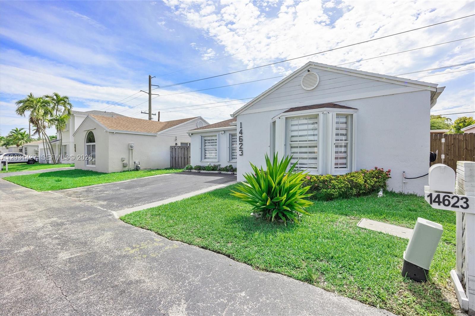 A single-story house with a white exterior, a bay window, and a paved driveway — 14623 SW 125th Pl, Miami FL 33186, MIAMI, FL