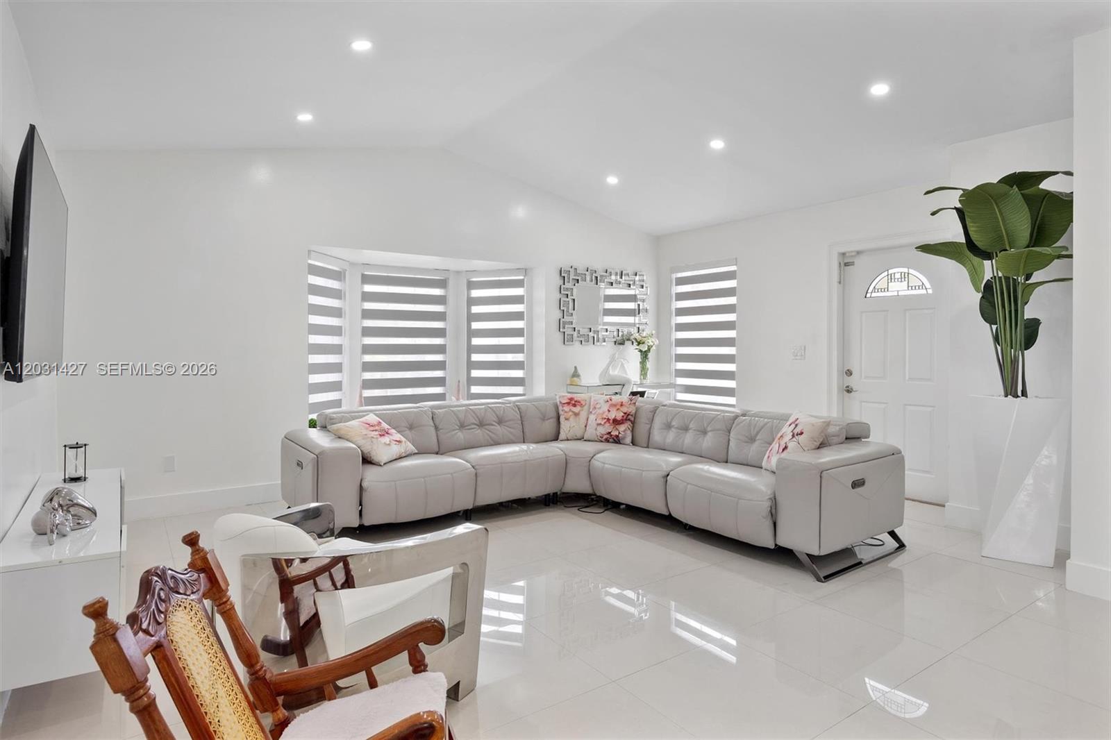 A bright living room features a light gray sectional sofa, white tile floors, and vaulted ceilings — 14623 SW 125th Pl, Miami FL 33186, MIAMI, FL