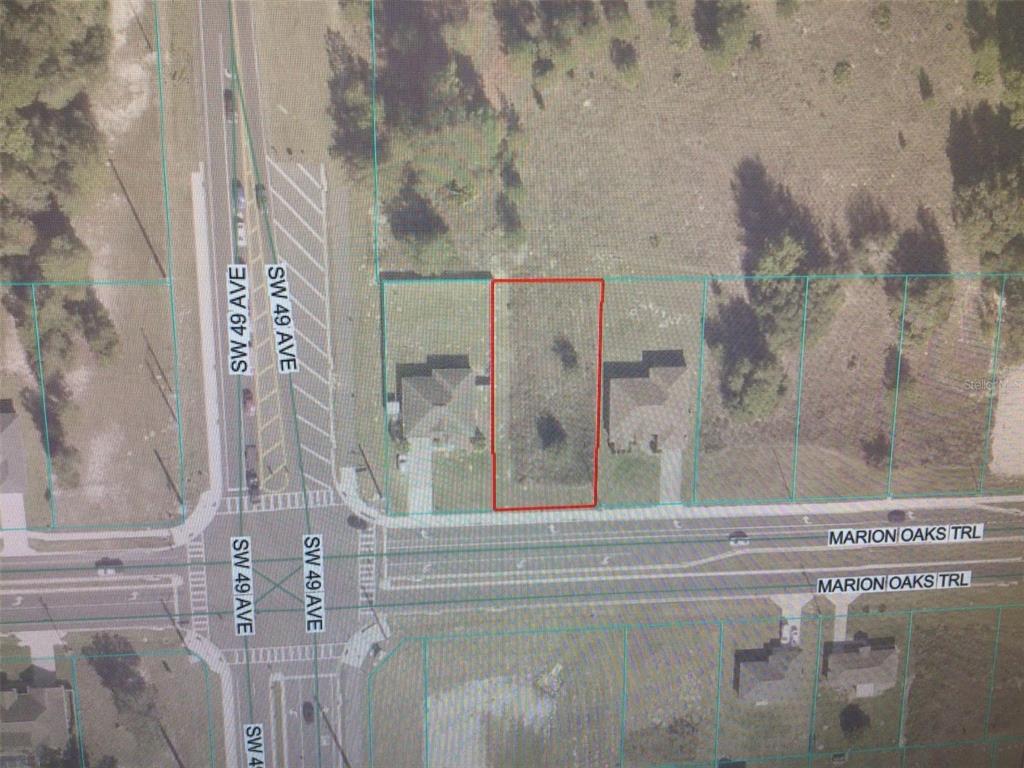 This is an aerial map showing a vacant residential lot outlined in red — 0 MARION OAKS TRAIL, OCALA, FL