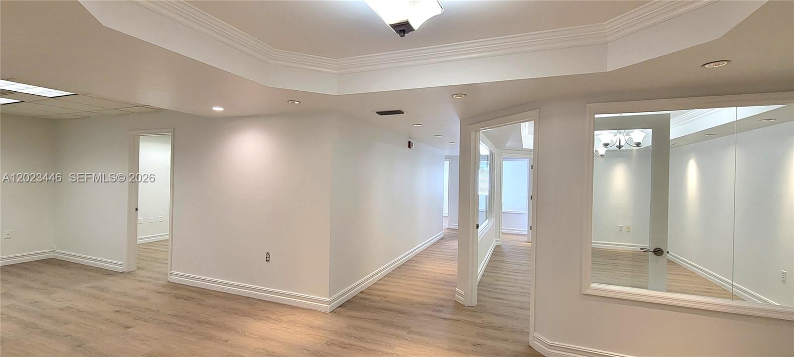 An interior view shows a hallway with light wood flooring and white walls — 7765 SW 87th Ave # 207A, Miami FL 33173, MIAMI, FL