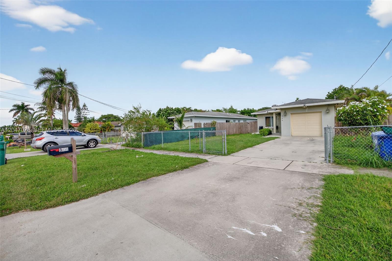 A single-story house with a concrete driveway, a garage, and a chain-link fence — 344 SW 3rd St, Florida City FL 33034, FLORIDA CITY, FL