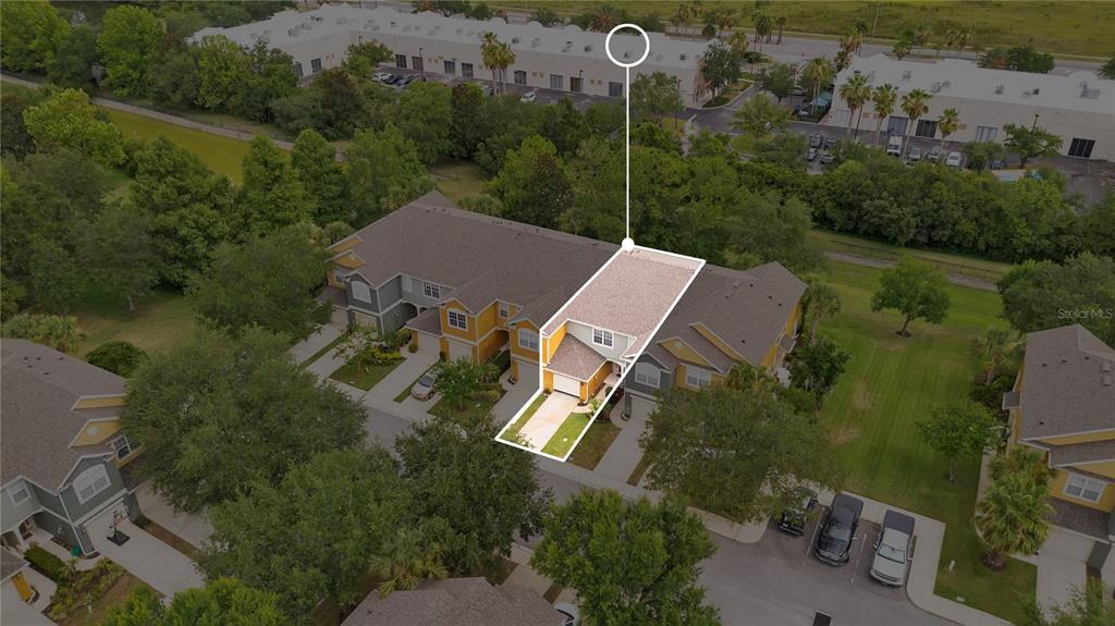 An aerial view shows a highlighted townhouse unit with a driveway and attached garage — 1122 BERKMAN CIRCLE, SANFORD, FL
