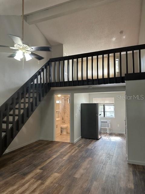A living room with wood-look flooring, a staircase, and a loft area overlooking the kitchen — 2122 BRADFORD STREET UNIT 521, CLEARWATER, FL