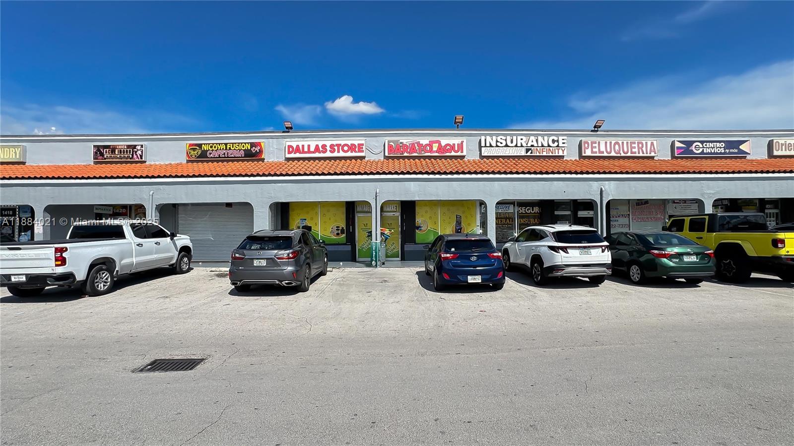 A strip mall exterior features multiple storefronts with signage above a parking lot — 1428-1430 W 49th Street, Hialeah FL 33012, HIALEAH, FL
