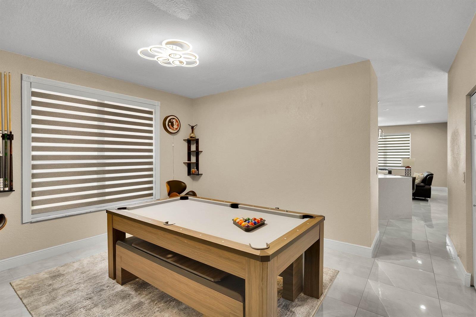 A game room features a pool table, light-colored tile flooring, and a modern ceiling light — 16254 SW 18th Place, Miramar FL 33027, MIRAMAR, FL