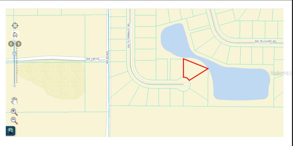 This map shows a vacant residential lot highlighted in red bordering a small lake — 00 SW 79 TERRACE ROAD, OCALA, FL