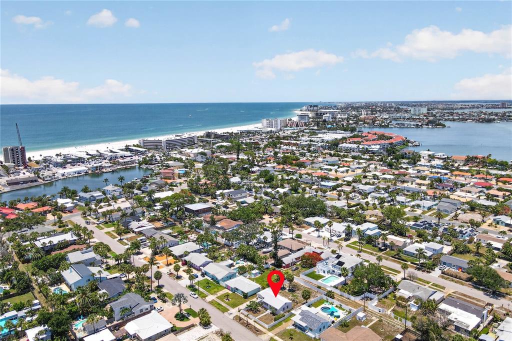 An aerial view shows a residential neighborhood near the coast with a red pin marking a house — 260 42ND AVENUE, ST PETE BEACH, FL