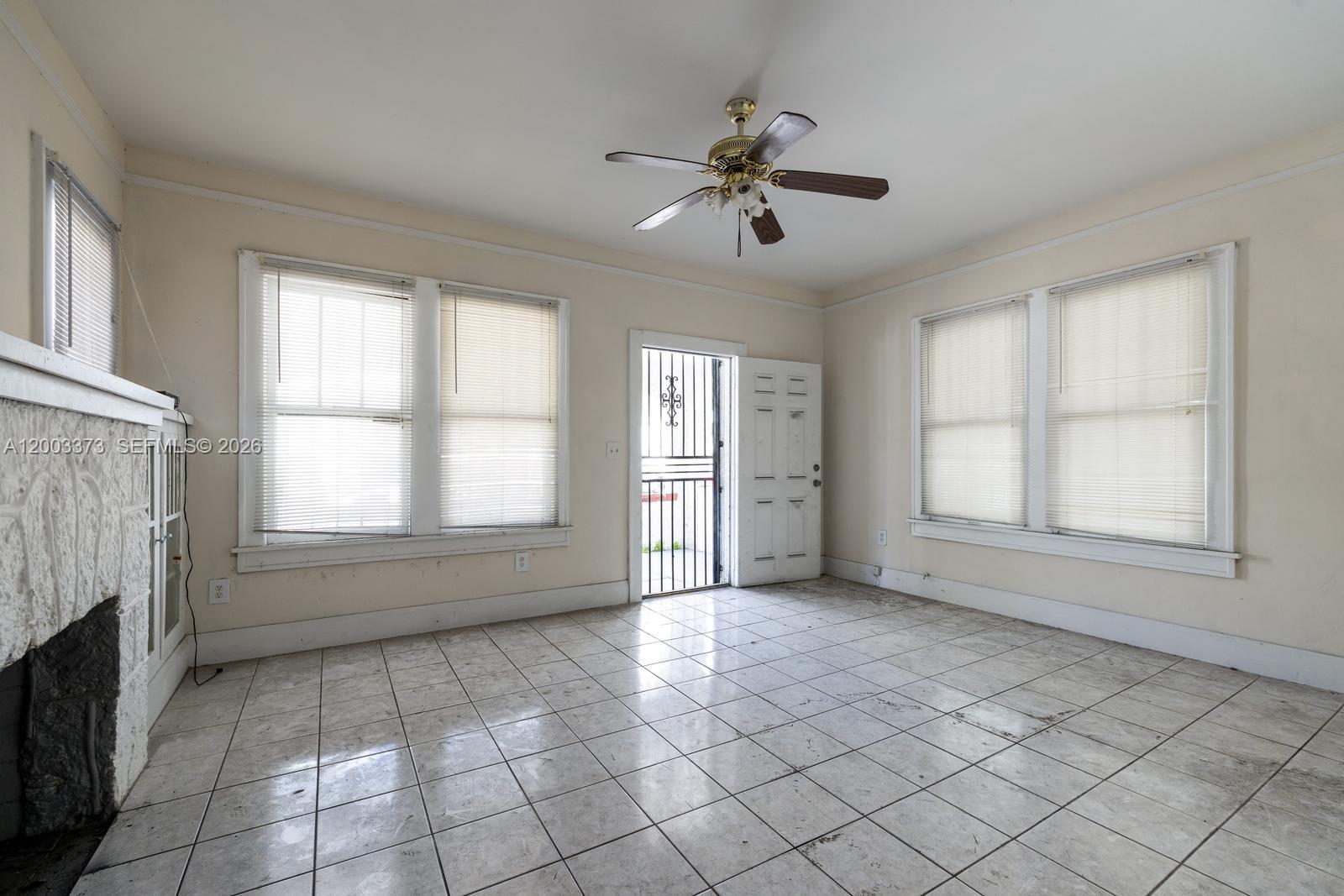A single-story white stucco house features an arched front porch and a chain-link fence — 311 SW 10th Ave, Miami FL 33130, MIAMI, FL