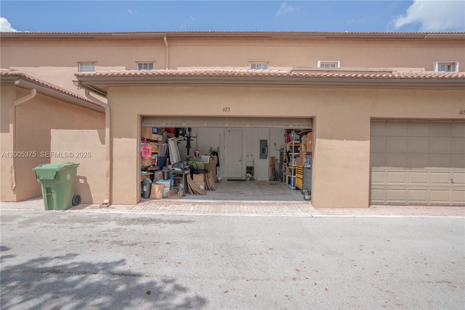 A virtually staged living room features a sectional sofa, round coffee table, and light flooring — 623 SW 146th Ter, Pembroke Pines FL 33027, PEMBROKE PINES, FL