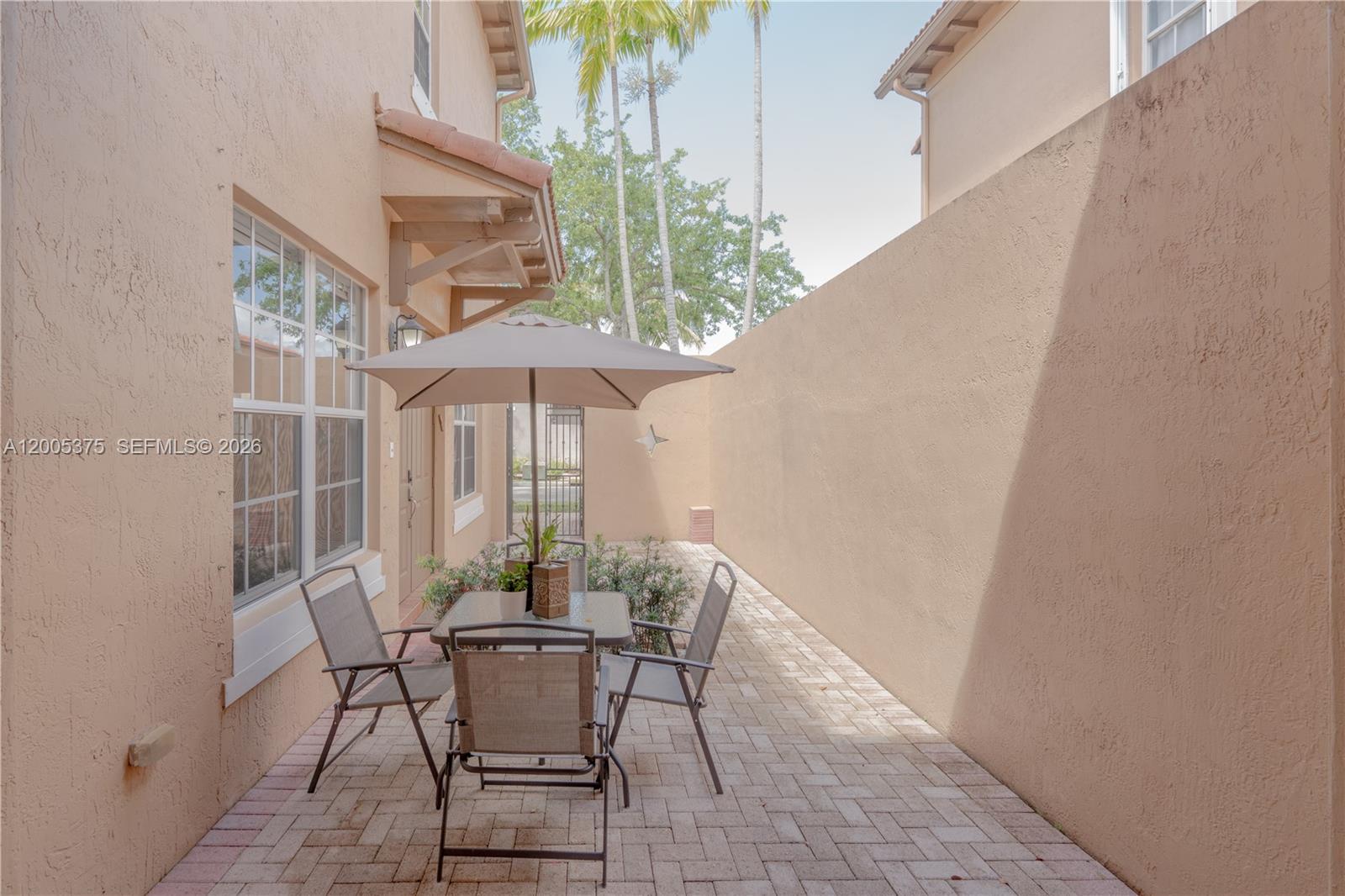 This bedroom features a bed, dresser, ceiling fan, and a door leading to a balcony — 623 SW 146th Ter, Pembroke Pines FL 33027, PEMBROKE PINES, FL