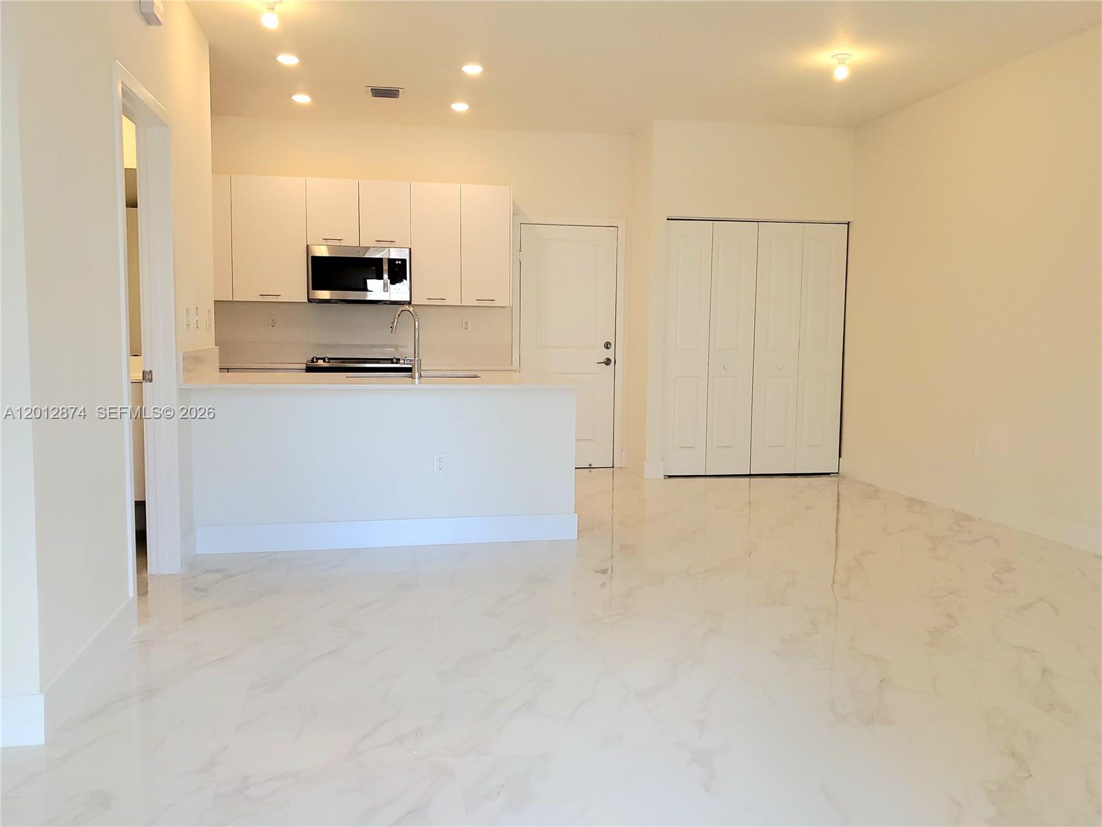 A two-story townhouse exterior features a balcony, stone-accented pillars, and a metal fence — 4278 NW 82nd Ave # 4278, Doral FL 33166, DORAL, FL