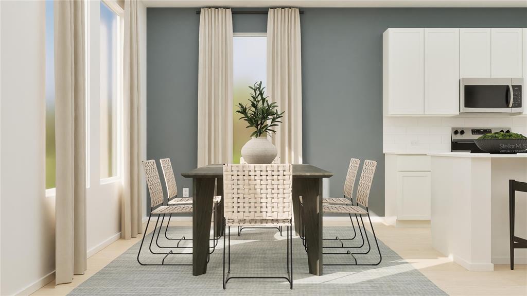 This is a digital rendering of a dining area with a table, chairs, and kitchen — 3043 GRANITE RIDGE AVENUE, MINNEOLA, FL