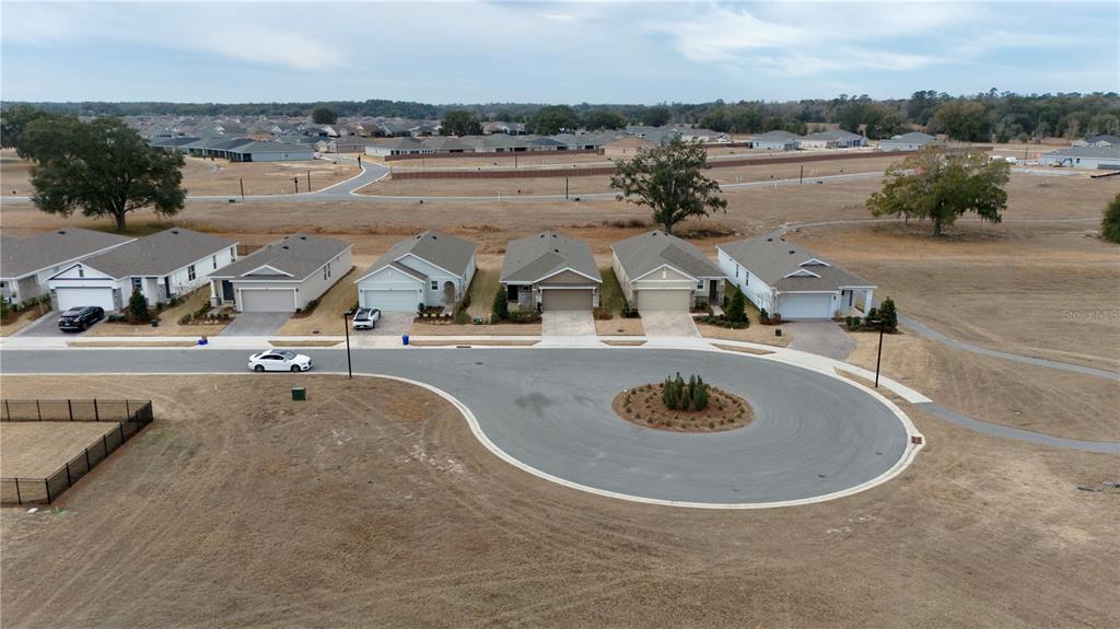 An aerial view shows a row of suburban houses along a cul-de-sac with surrounding land — 5464 NW 46TH LANE ROAD, OCALA, FL
