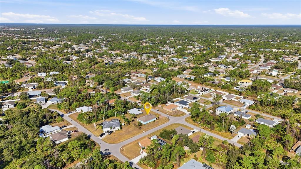 An aerial view shows a residential neighborhood with a yellow location marker on a house — 2309 PILGER AVENUE, NORTH PORT, FL