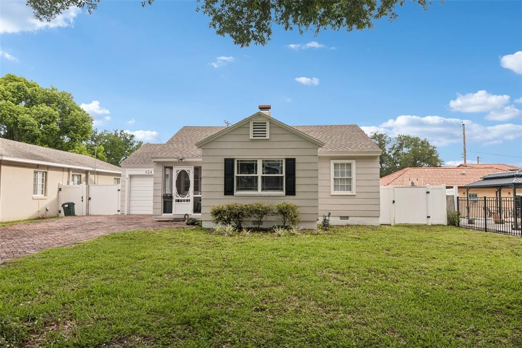 A single-story house with light gray siding, a front lawn, and a paved driveway — 624 KERNEYWOOD STREET, LAKELAND, FL