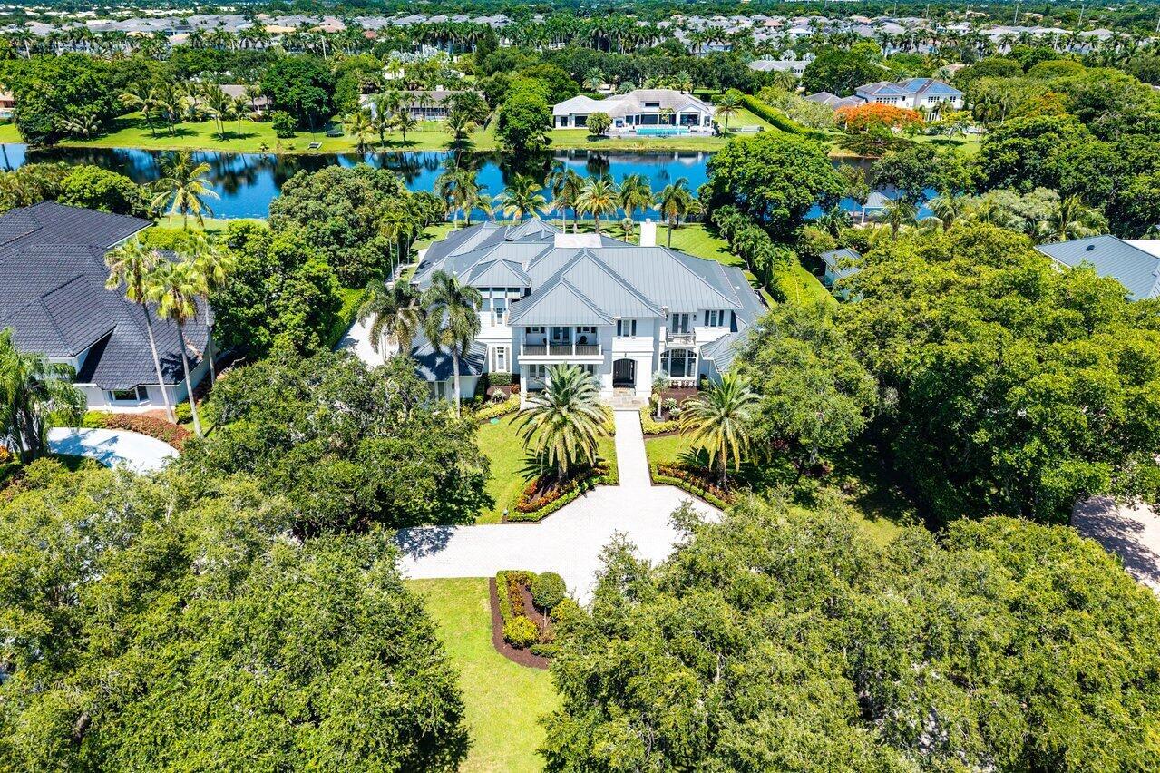 An aerial view of a large multi-story house with a metal roof and swimming pool — 17837 Fieldbrook Circle W, Boca Raton FL 33496, BOCA RATON, FL