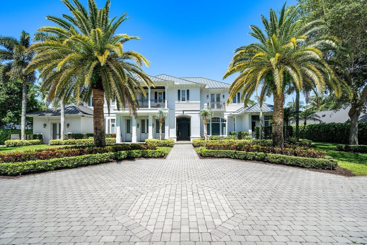 A two-story white house with a paved driveway and palm trees under a clear sky — 17837 Fieldbrook Circle W, Boca Raton FL 33496, BOCA RATON, FL