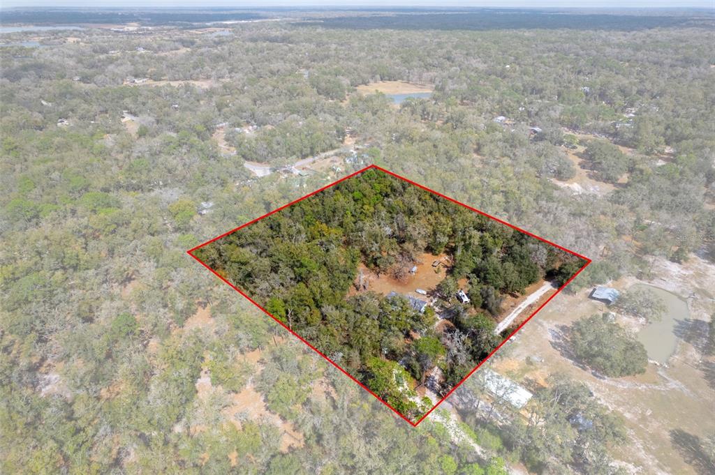 An aerial view shows a wooded plot of land outlined in red with a driveway — 11881 SW 45TH STREET, WEBSTER, FL