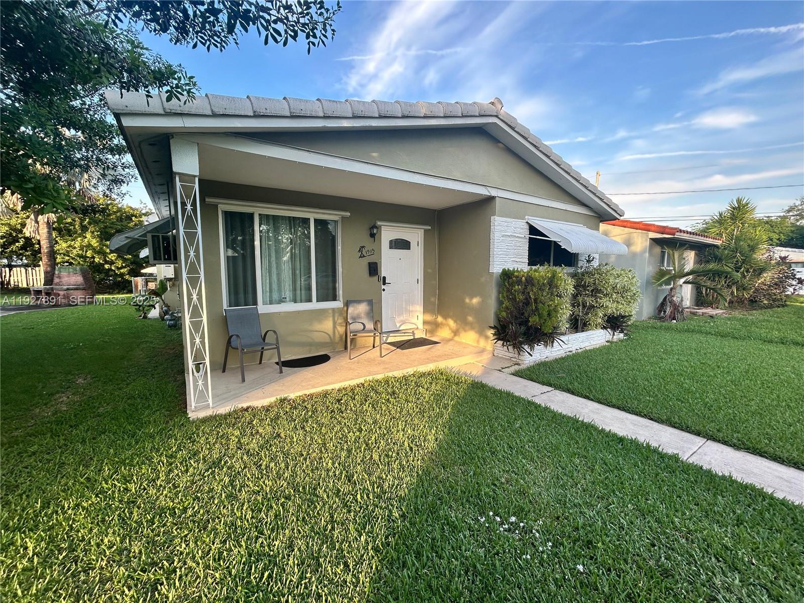 A single-story house with a green exterior, white brick accents, and a front walkway — 1915 Mayo St, Hollywood FL 33020, HOLLYWOOD, FL