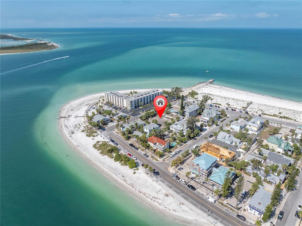 An aerial view shows a coastal neighborhood with a red location pin on a lot — 103 & 105 1ST AVENUE, ST PETE BEACH, FL