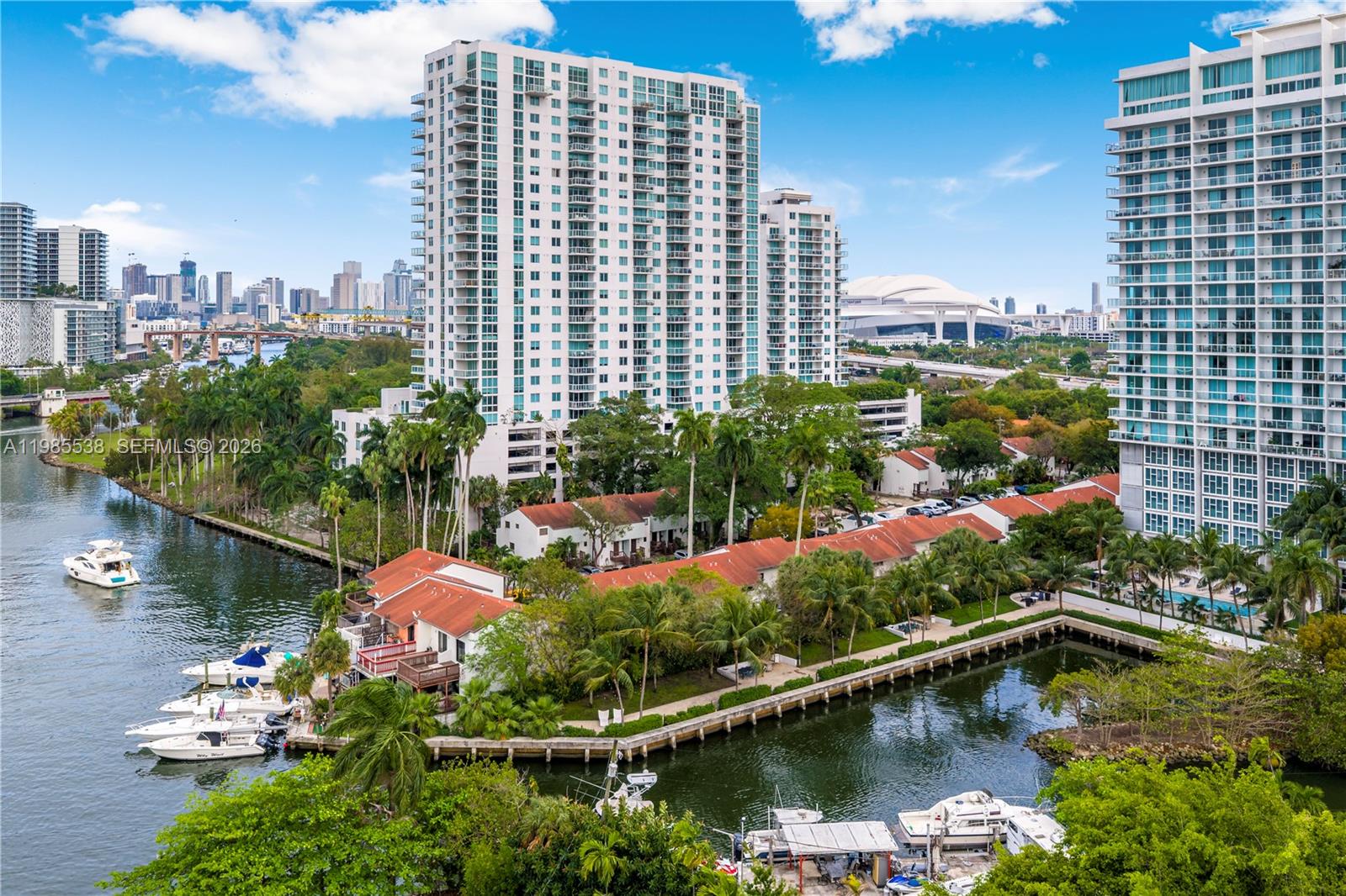 An aerial view shows a waterfront residential complex with boats docked near high-rise buildings — 1901 NW S River Dr # 30C, Miami FL 33125, MIAMI, FL