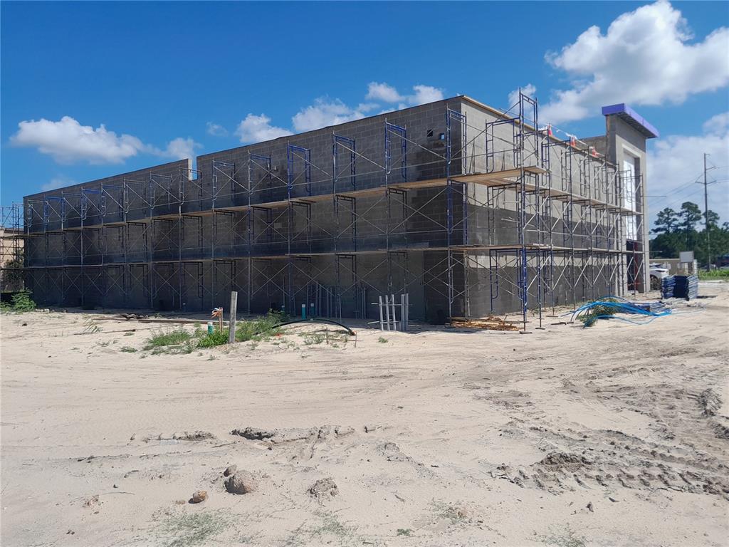 A partially constructed commercial building with scaffolding surrounding its concrete block exterior walls — 11697 PANAMA CITY BEACH PARKWAY, PANAMA CITY BEACH, FL