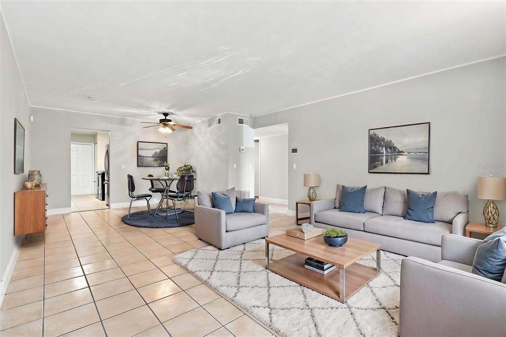 A living room and dining area with tile floors, neutral walls, and modern furniture — 605 NORTHLAKE BOULEVARD UNIT 33, ALTAMONTE SPRINGS, FL