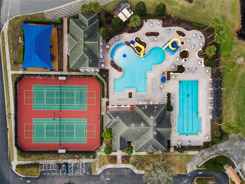 An aerial view shows a community recreation area with two tennis courts and two swimming pools — 3050 CAMDEN WAY, DAVENPORT, FL