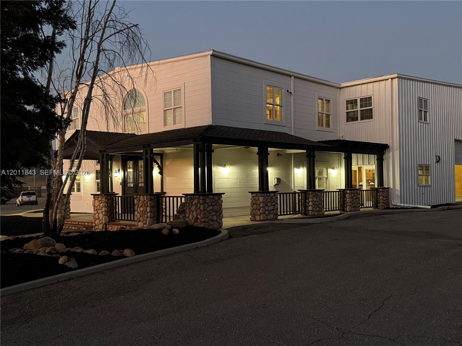 A two-story building features a covered porch with stone pillars and metal siding — 428 NORTH CURRY STREET # 0, CA 93561, CA